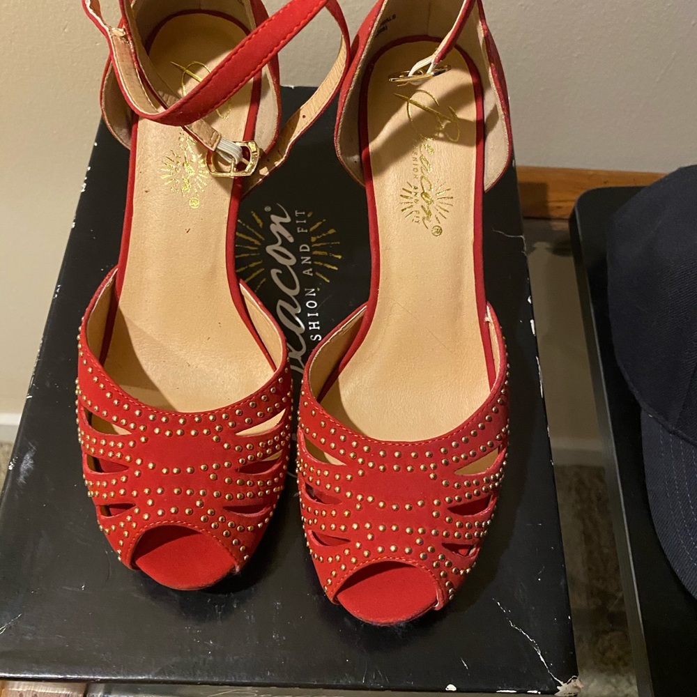 Red 4” inch strappy high heels with gold stems.